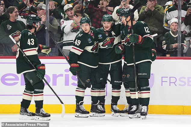 Minnesota Wild left wing Kirill Kaprizov (97) celebrates with teammates after scoring during the second period of an NHL hockey game against the Columbus Blue Jackets, Sunday, Oct. 18, 2026, in St. Paul, Minn. (AP Photo/Abbie Parr)