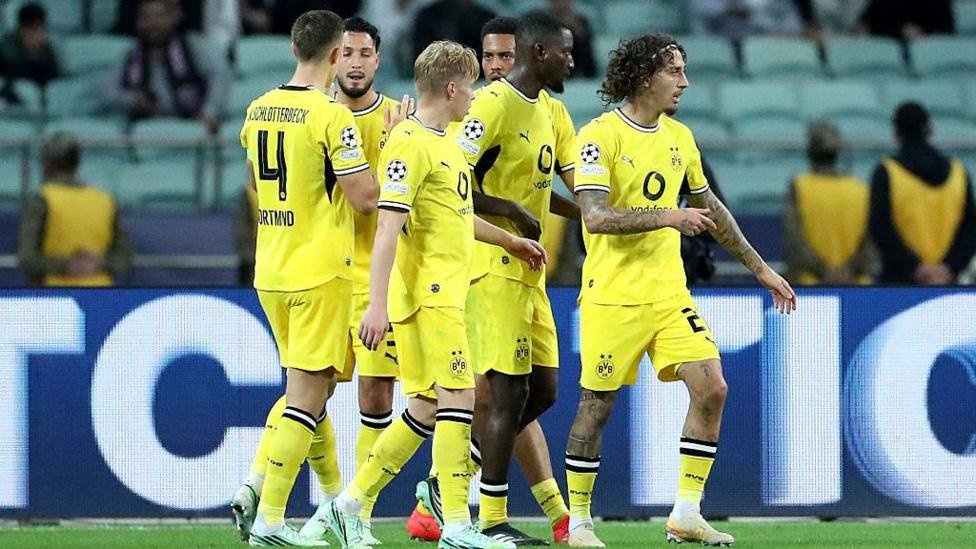 Borussia Dortmund players celebrate scoring against Sabah in the Champions League
