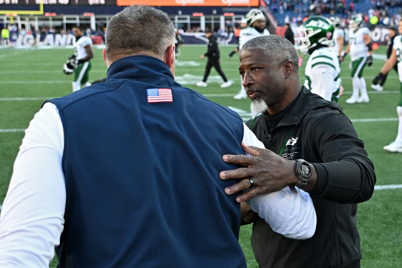 Aaron Glenn and Mike Vrabel shake hands