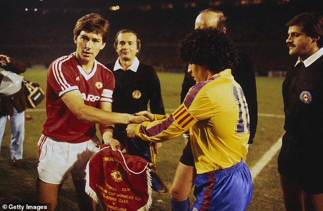 Manchester United captain Bryan Robson exchanges pennants with Barcelona's Diego Maradona ahead of the second leg