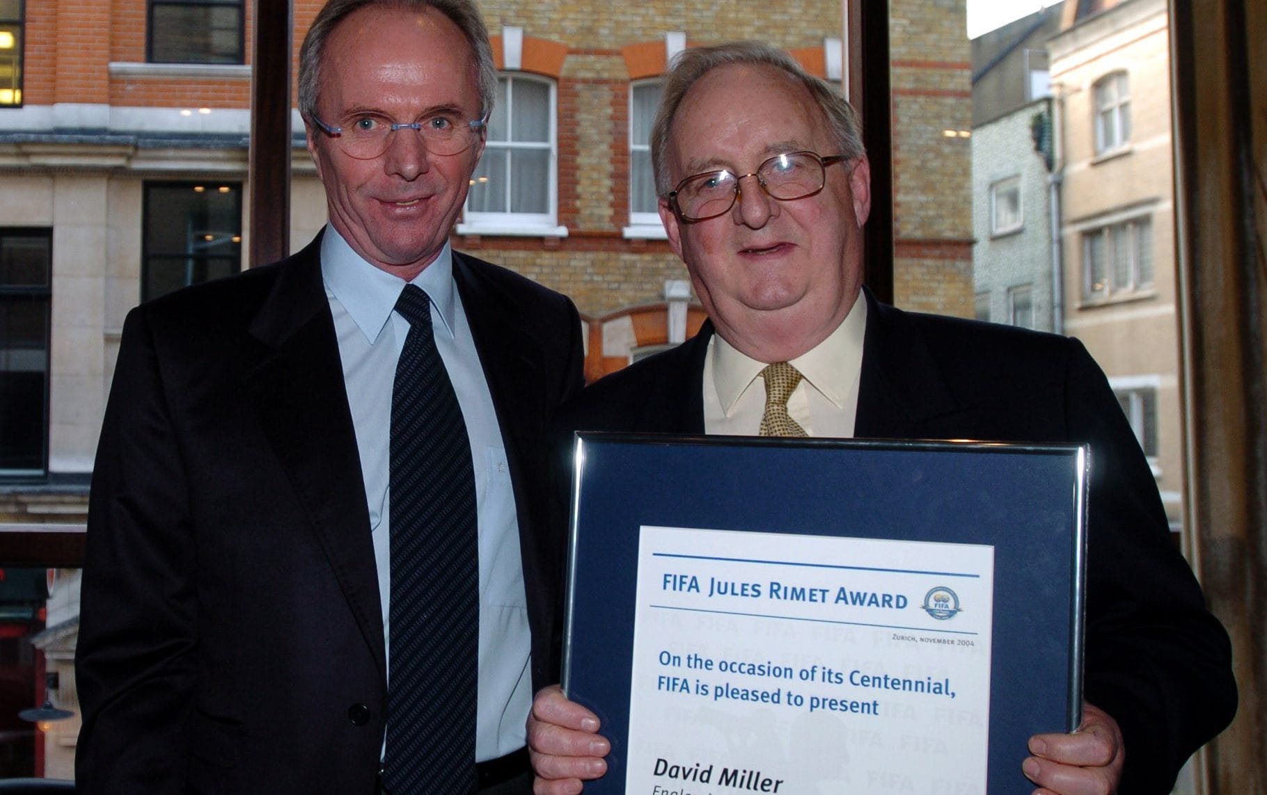 David Miller in 2004, receiving the Fifa Jules Rimet Award from the England manager Sven-Goran Eriksson