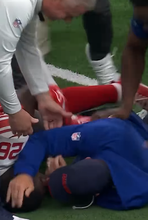 John Harbaugh is tackled by Devin Singletary after the Giants' win.