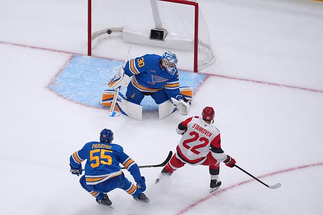 Carolina Hurricanes' Logan Stankoven (22) scores past St. Louis Blues goaltender Joel Hofer (30) and Colton Parayko (55) during the second period of an NHL hockey game Saturday, Oct. 24, 2026, in St. Louis. (AP Photo/Jeff Roberson)