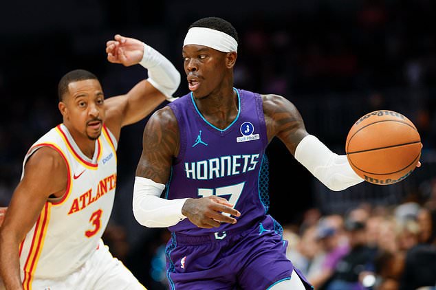 Charlotte Hornets guard Dennis Schroder, right, moves the ball against Atlanta Hawks guard CJ McCollum, left, during the first half of an NBA basketball game in Charlotte, N.C., Friday, Oct. 23, 2026. (AP Photo/Nell Redmond)