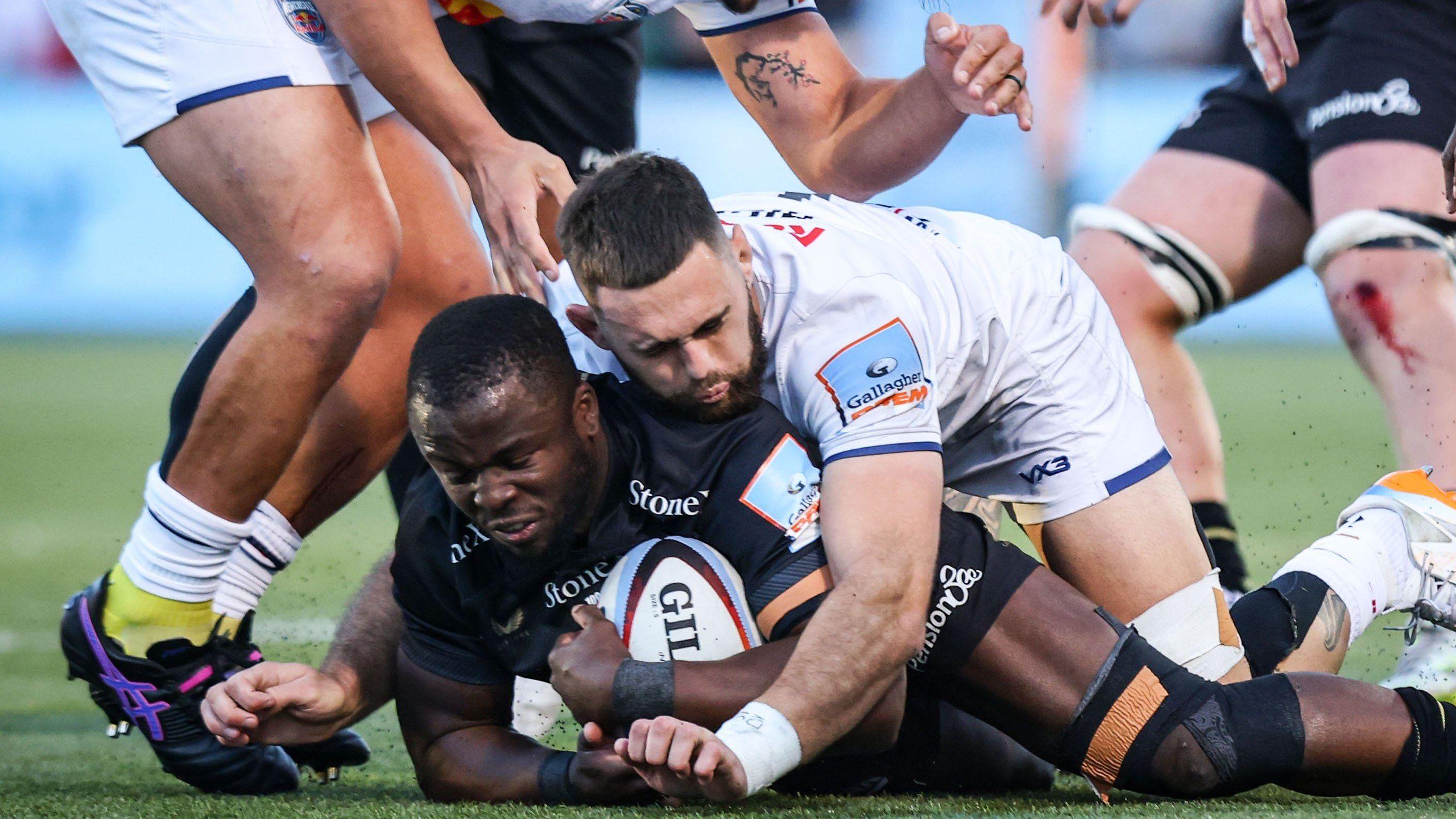 Rotimi Segun has the ball on the floor with Newcastle forward Max Hicks on top of him