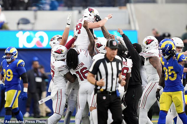Arizona Cardinals kicker Chad Ryland, top, is congratulated by teammates after kicking the game winning field goal against the Los Angeles Rams during the second half of an NFL football game in Inglewood, Calif., Sunday, Oct. 18, 2026. (AP Photo/Gregory Bull)