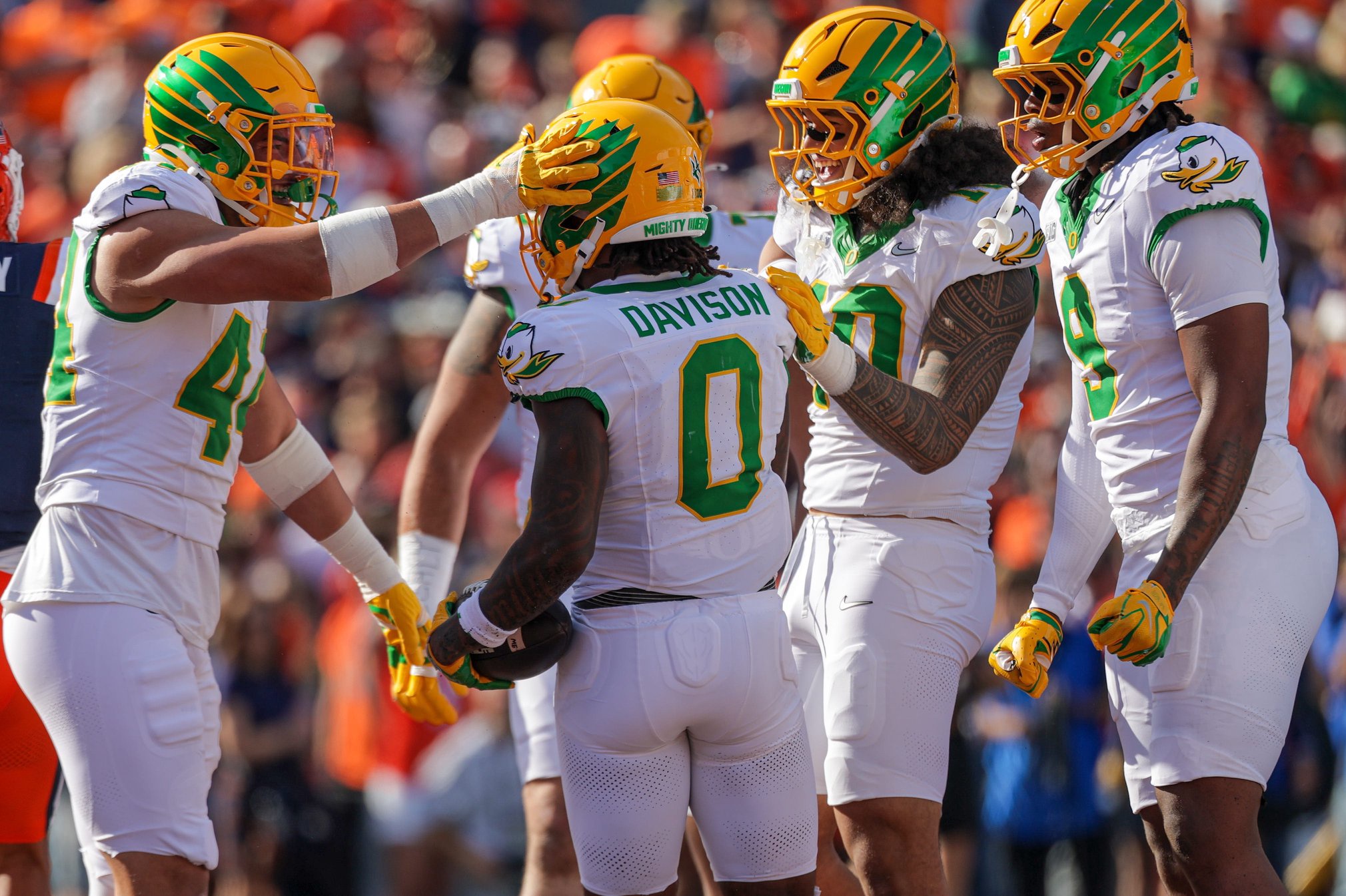 Members of the Oregon Ducks offense celebrate with Oregon running back Jordon Davison after a touchdown against the Illinois Fighting Illini during the first half at Memorial Stadium on October 24, 2026 in Champaign, Illinois.