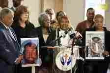 Bettersten Wade, mother of Dexter Wade, 37, center, joins Gretchen Hankins, mother of Jonathan Hankins, 39, left, and Mary Moore Glenn, mother of Marrio Moore, 40, calls out for justice in speaking at a press conference about their cases