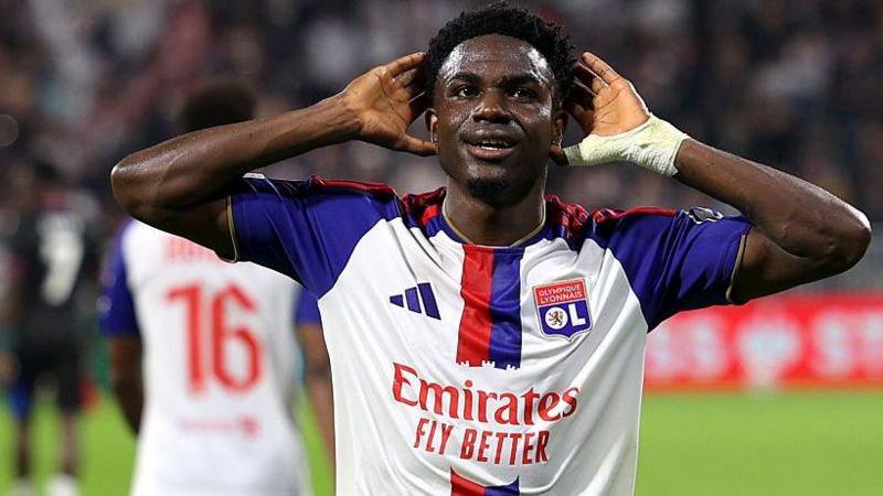 Ernest Nuamah celebrates scoring a goal for Lyon