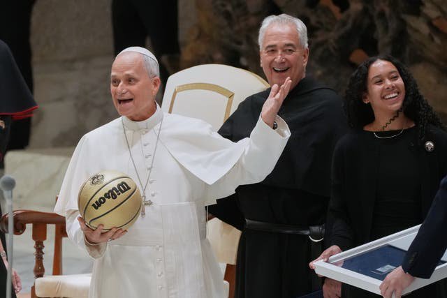 Basketball player Jasmine Bascoe along with Villanova University President Peter M. Donohue, present Pope Leo XIV with a basketball in the Paul VI Hall at the Vatican, Saturday, Oct. 31, 2026