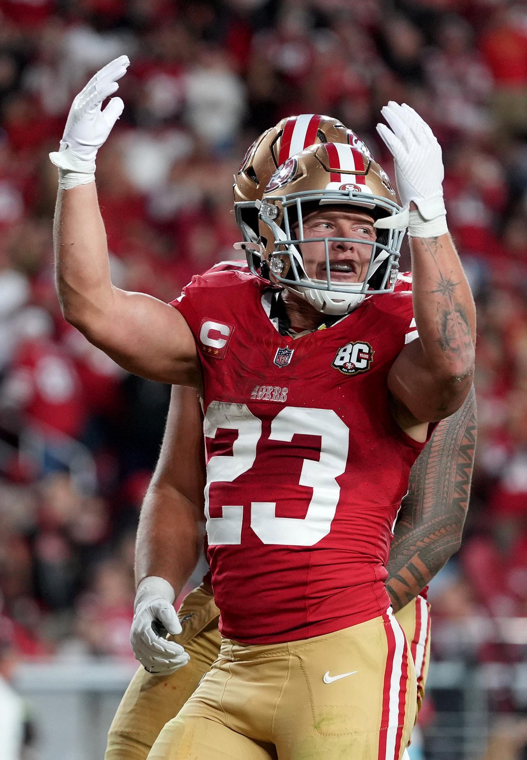San Francisco 49ers' Christian McCaffrey celebrates after scoring a touchdown against the Washington Commanders.
