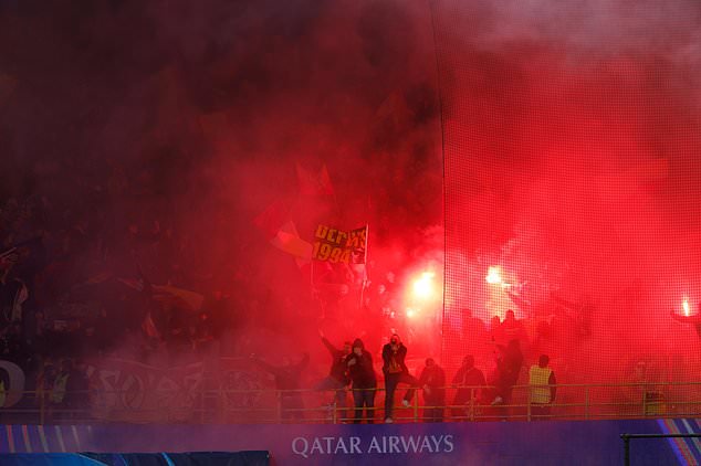 Lens supporters light flares during the Champions League opening phase soccer match between Club Brugge and Lens in Bruges, Belgium, Wednesday, Oct. 21, 2026. (AP Photo/Geert Vanden Wijngaert)