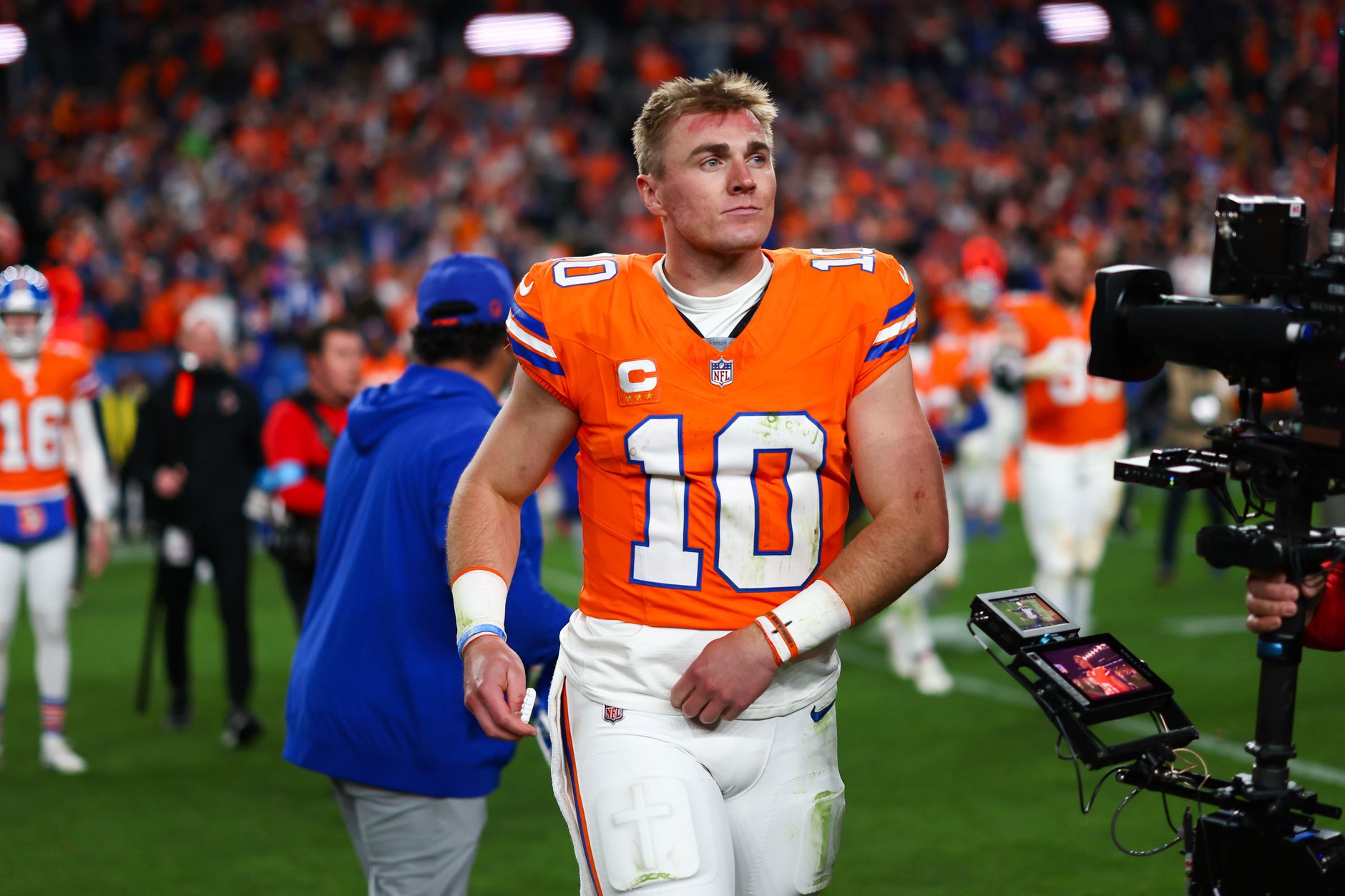 Bo Nix 10 of the Denver Broncos walks off the field after winning in overtime against the Seattle Seahawks at Empower Field At Mile High on October 15, 2026 in Denver, Colorado. 