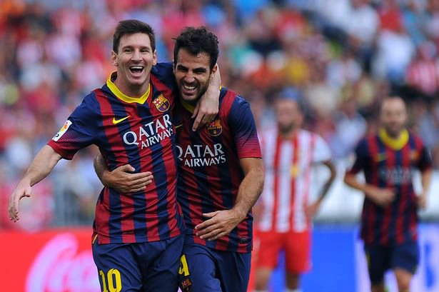 Barcelona's Argentinian forward Lionel Messi (L) celebrates with midfielder Cesc Fabregas after scoring during the Spanish league football match UD Almeria vs FC Barcelona at the Juegos Mediterraneos stadium in Almeria on September 28, 2013