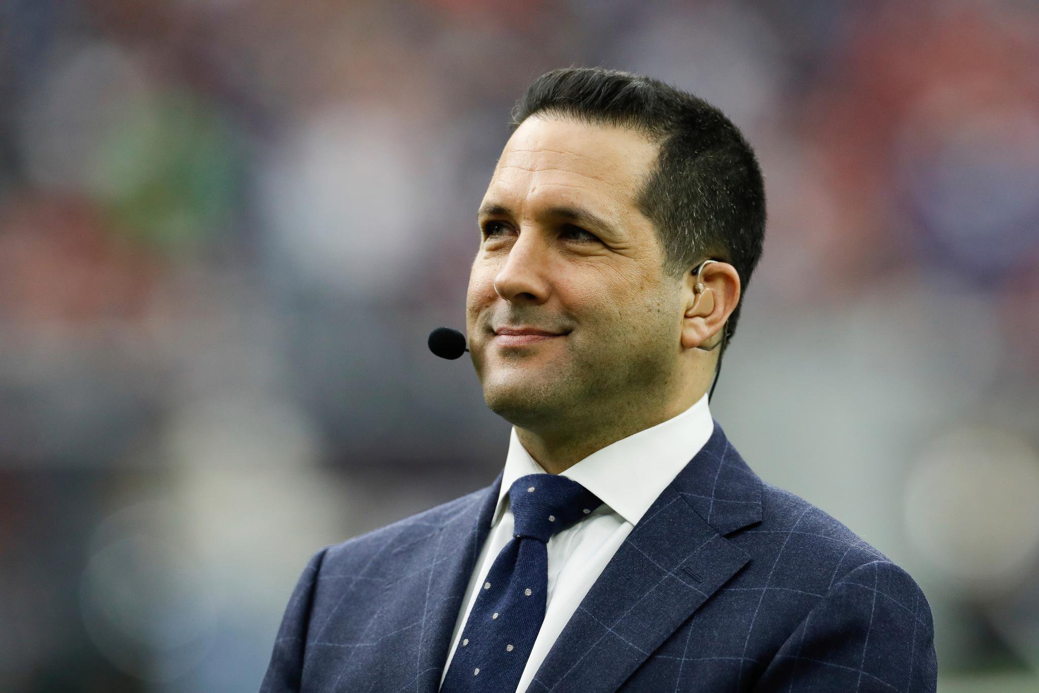 ESPN NFL insider Adam Schefter stands prior to an NFL wild-card playoff football game between the Houston Texans and the Buffalo Bills on Saturday, Jan. 4, 2020, in Houston. Houston won 22-19 in overtime.