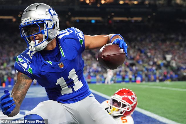 Seattle Seahawks wide receiver Jaxon Smith-Njigba (11) reacts after a catch for a touchdown in front of Kansas City Chiefs cornerback Mansoor Delane (5) during the first half of an NFL football game in Seattle, Sunday, Oct. 25, 2026. (AP Photo/Lindsey Wasson)