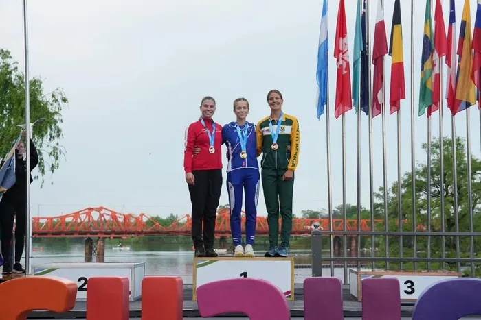 South Africa’s Georgia Singe (right) celebrates on the bronze medal step after competing in the Women’s Under-23 K1 distance event at the ICF Canoe Marathon World Championships in Gualeguaychú, Argentina, alongside gold medalist Romana Svecova of Slovakia (center) and silver medalist Sophie Hansen of Denmark (left).