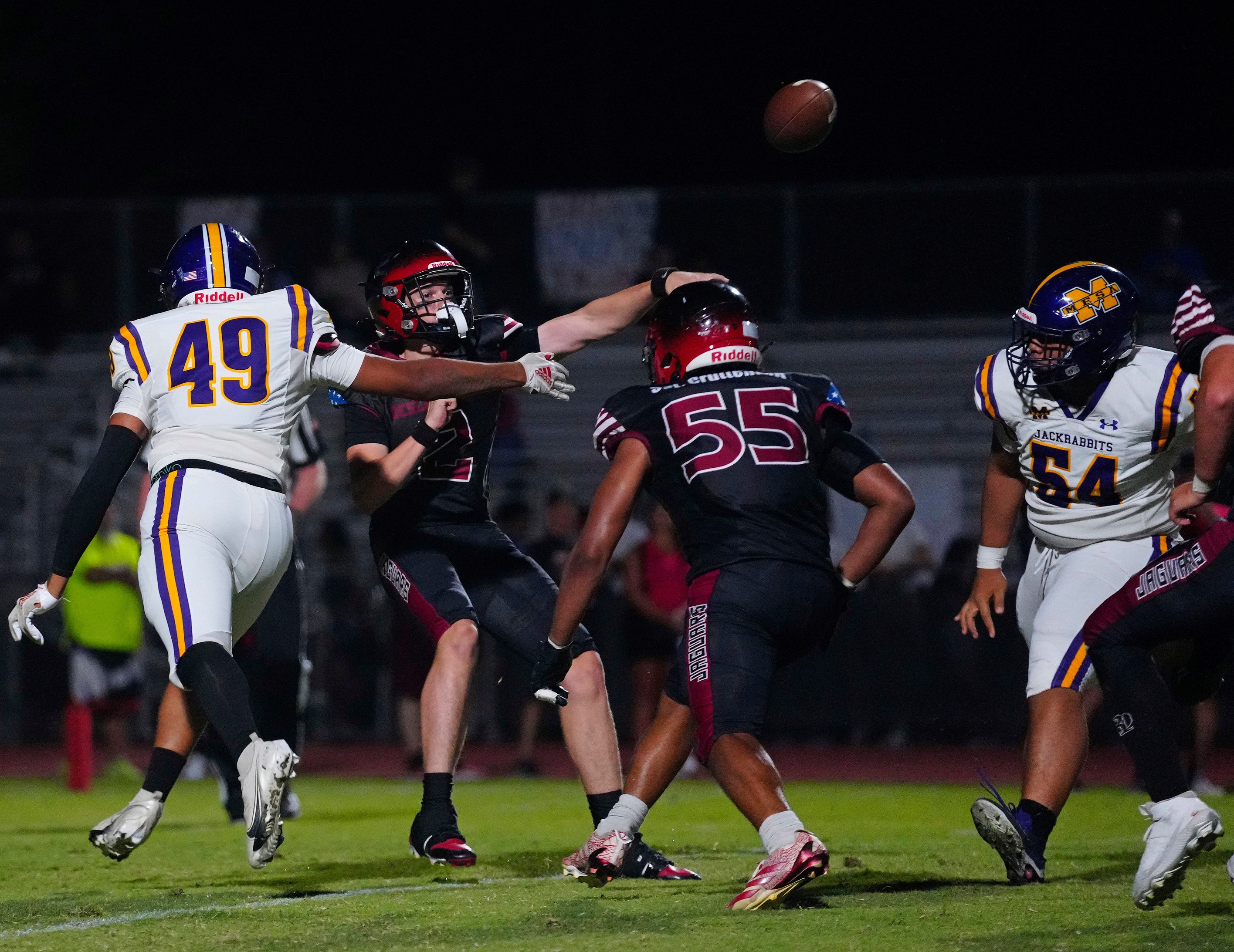 Desert Ridge quarterback Gunner Brewer (2) throws a pass under pressure from Mesa during a game at Desert Ridge High School in Mesa, on Sept. 18, 2025.