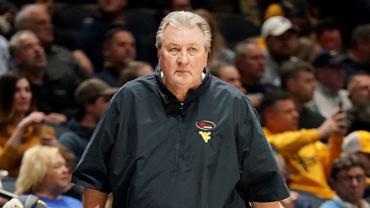 Bob Huggins, head coach of the West Virginia Mountaineers, looks on during a college basketball game.