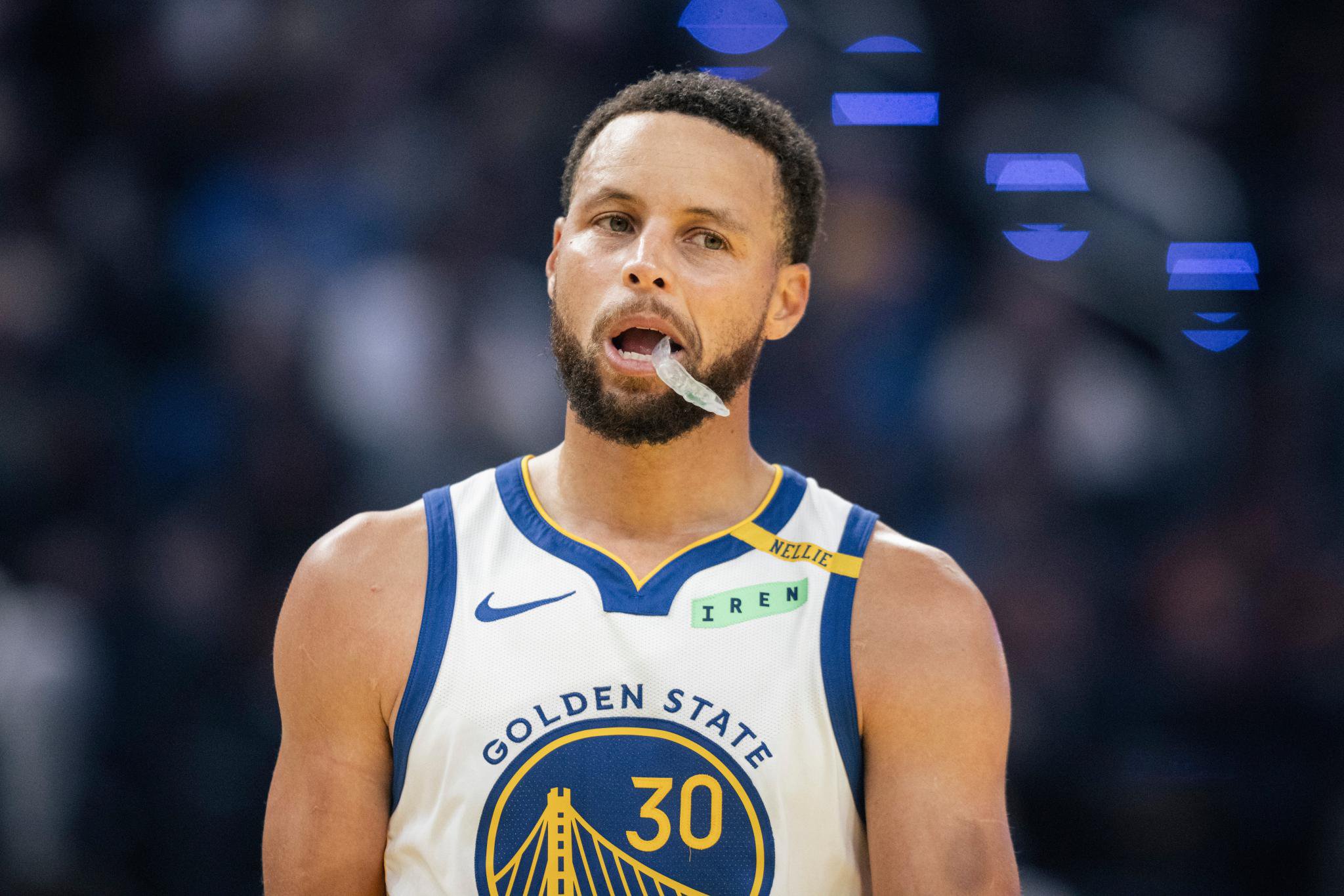 Stephen Curry of the Golden State Warriors wearing his mouthguard on the court.