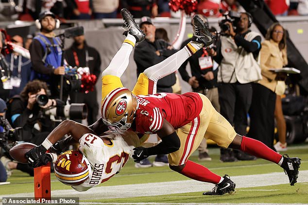Washington Commanders wide receiver Treylon Burks (13) cannot catch a pass while being defended by San Francisco 49ers safety Malik Mustapha during the second half of an NFL football game in Santa Clara, Calif., Monday, Oct. 19, 2026. (AP Photo/Kelley L. Cox)