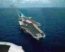 An aerial starboard bow view of the aircraft carrier USS America (CV-66).