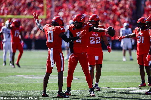 Cincinnati cornerback Jacob Finley (0) and safety Mj Cannon (2) celebrate after Cannon intercepted a pass during the first half of an NCAA college football game against Texas Tech, Saturday, Oct. 24 2026, in Cincinnati. (AP Photo/Lydia Schembre)