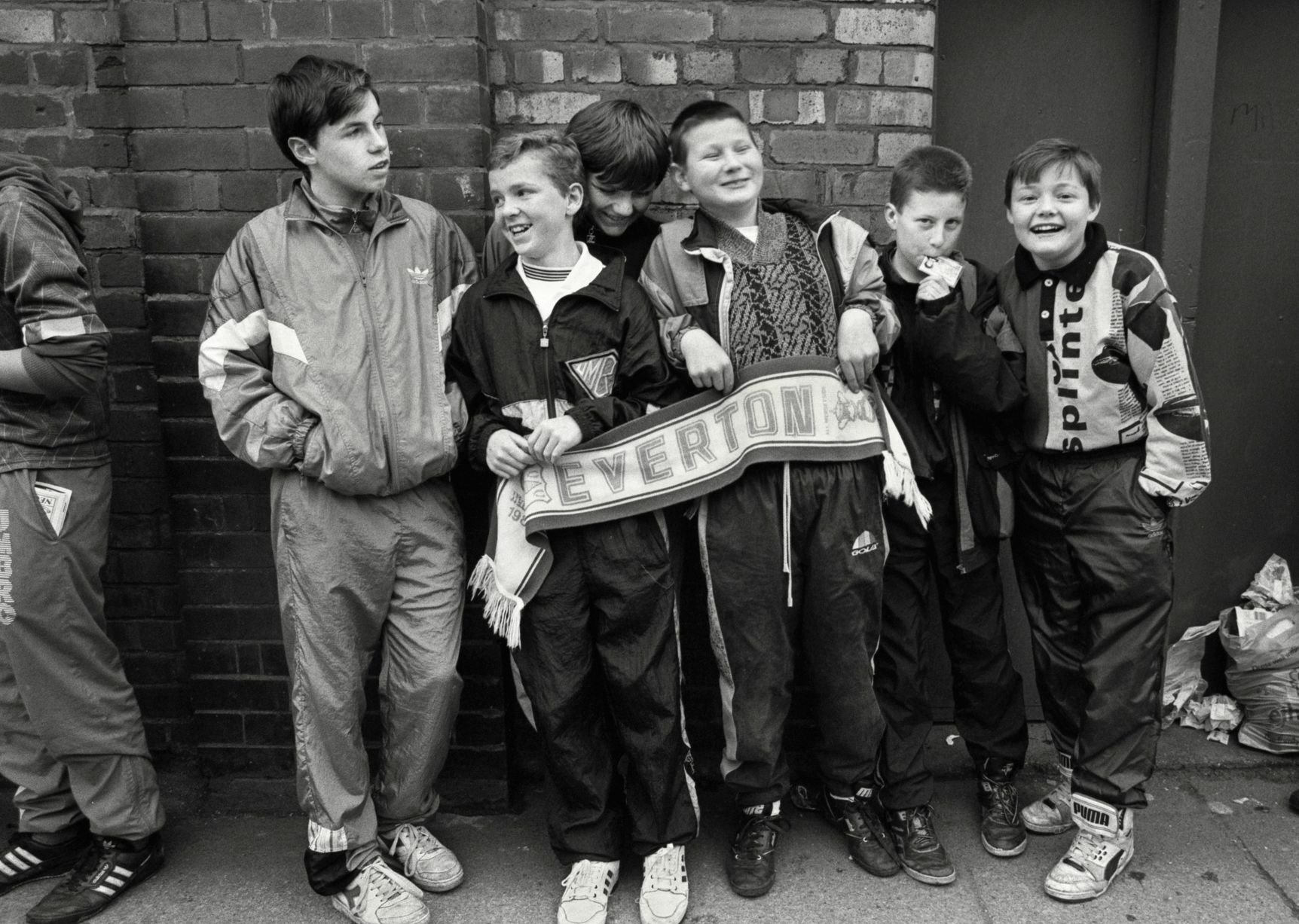 In 1991, photographer Richard Davis followed supporters from across the North West for a book about football, fashion and music. Richard spent much of the season taking pictures of fans from Liverpool, Everton and more for the book Football With Attitude. In collaboration with Lower Block, the Going to the Match zine has been published to coincide with an exhibition of the same name at Bury Art Museum, running from October 2024 to March 2025.
Pictured: Everton Fans at Goodison Park, 1991