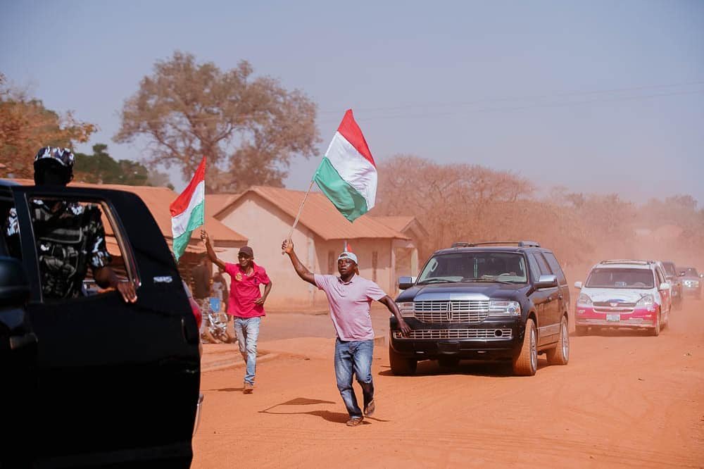 May be an image of 2 people, people standing, road and sky