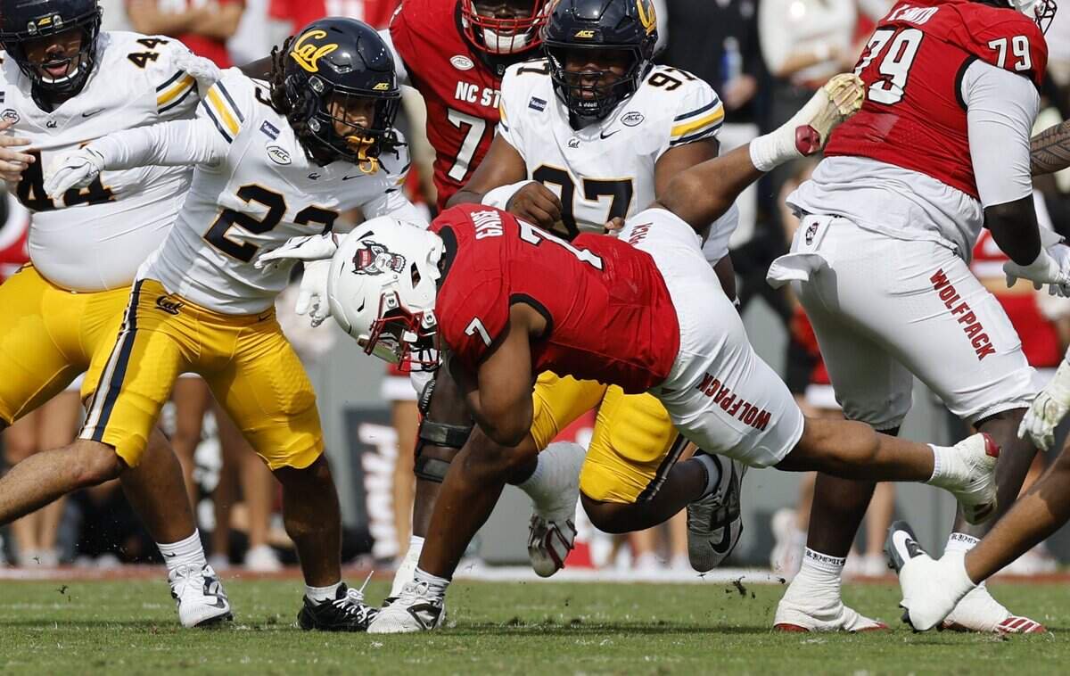 N.C. State running back Davion Gause (7) is stopped by California defensive back Isaiah Crosby (23) during the first half of N.C. State’s game against California at Cater-Finley Stadium in Raleigh, N.C., Saturday, Oct. 31, 2026.