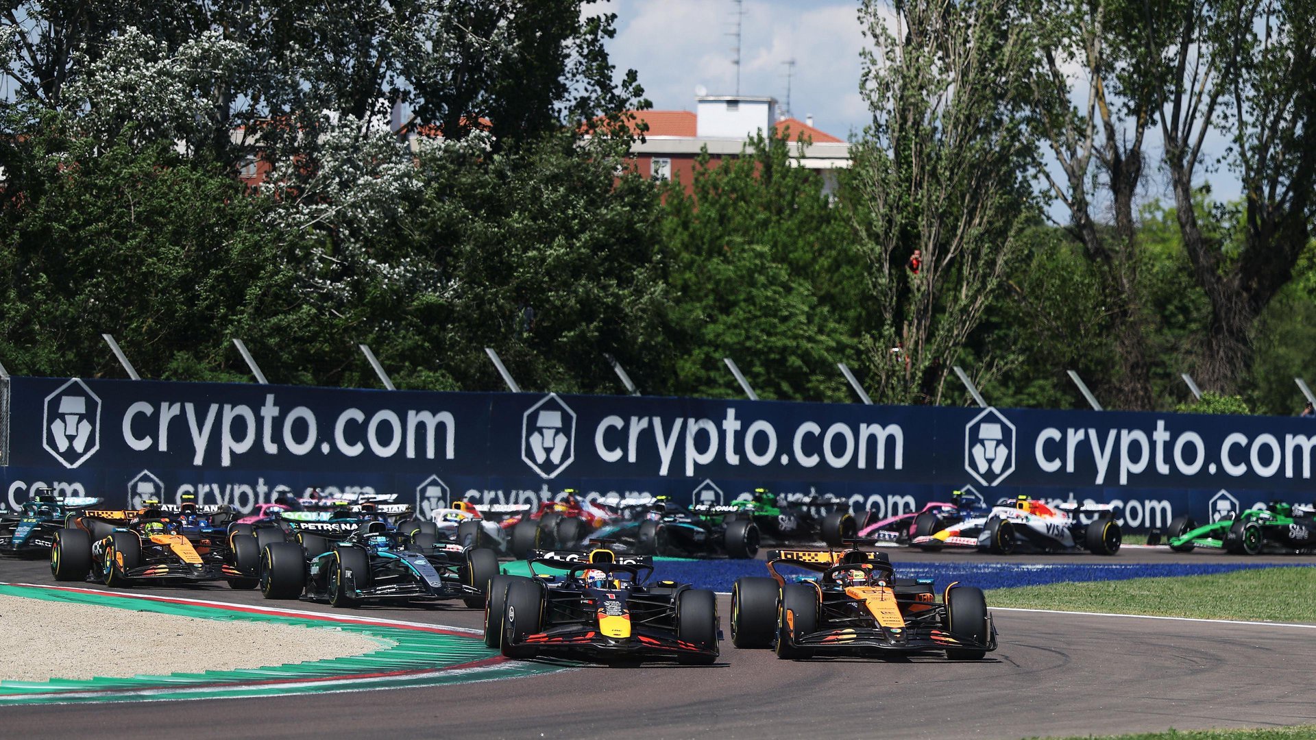 Red Bull's Max Verstappen passes McLaren's Oscar Piastri to take the lead at the first corner of the 2025 Emilia-Romagna Grand Prix