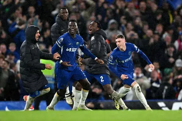 Cole Palmer of Chelsea celebrates scoring his team's fourth goal with teammates during the Premier League match between Chelsea FC and Manchester United at Stamford Bridge on April 04, 2024 in London, England