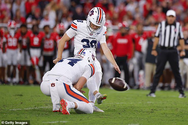 Alex McPherson of Auburn kicks a field goal to win the game against the Bulldogs