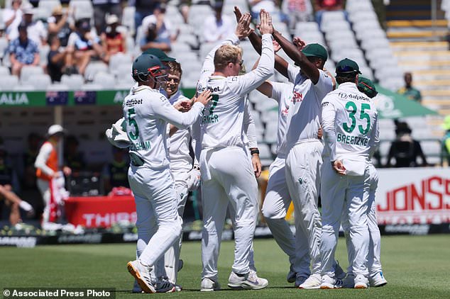 South Africa's Simon Harmer celebrates with teammates the wicket of Australia's Marnus Labuschagne, on day two of the third cricket test match between South Africa and Australia, in Cape Town, South Africa, Wednesday, Oct. 28, 2026. (AP Photo/Halden Krog)