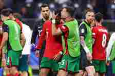Cristiano Ronaldo of Portugal visibly upset after missing a penalty is spoken to by Diogo Dalot of Portugal during the UEFA EURO 2024 round of 16 m...