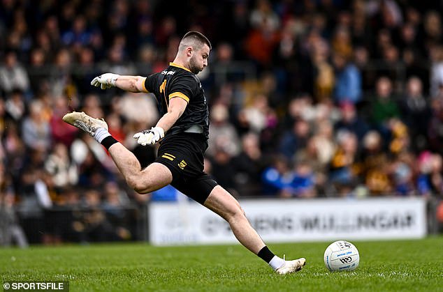 The Downs goalkeeper Trevor Martin kicks out against St Loman's Mullingar last week
