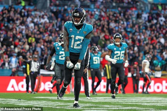 Jacksonville Jaguars wide receiver Travis Hunter (12) celebrates after making an interception during an NFL football game against Houston Texans in London, Sunday, Oct. 18, 2026. (AP Photo/Ian Walton)