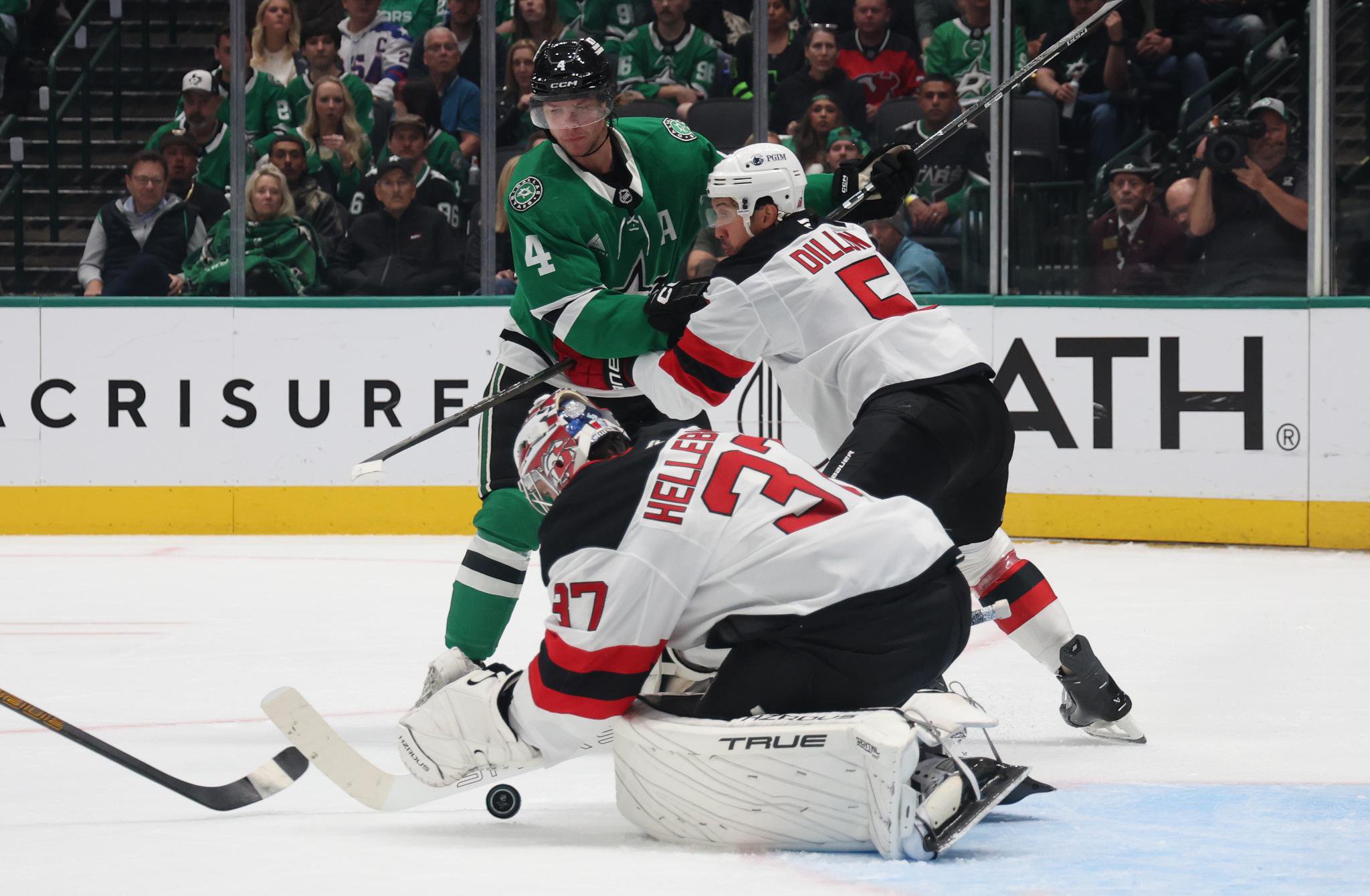 New Jersey Devils goaltender Connor Hellebuyck blocks a shot in front of the net against the Dallas Stars.