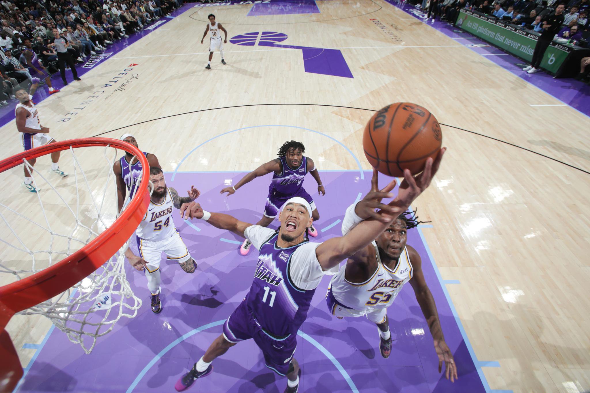 Jaxson Hayes #11 of the Utah Jazz and Kevon Looney #55 of the Los Angeles Lakers go for a rebound during a game.