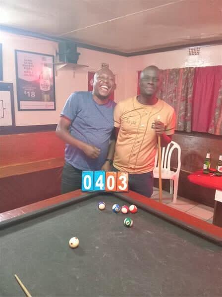 two men at a pool table