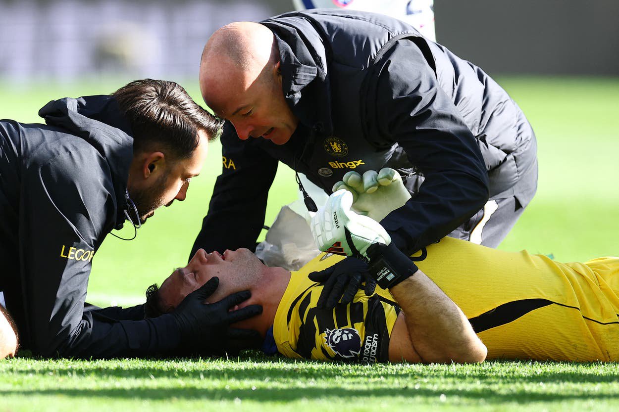 Chelsea's Emiliano Martinez receives medical attention after sustaining a head injury