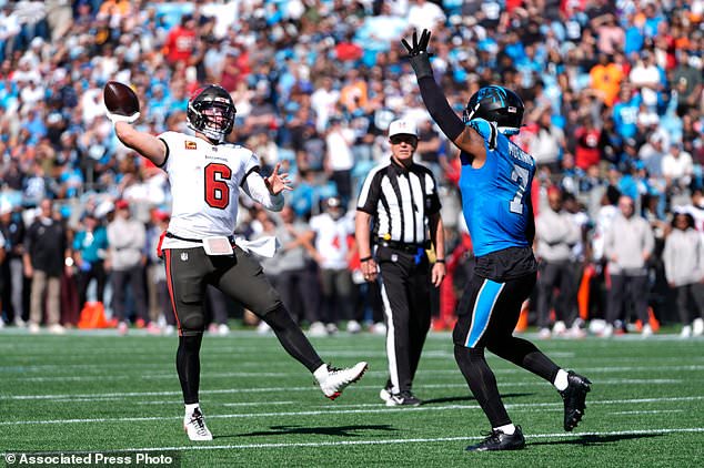 Tampa Bay Buccaneers quarterback Baker Mayfield (6) throws a touchdown pass over Carolina Panthers' Tre'von Moehrig (7) during the first half of an NFL football game in Charlotte, N.C., Sunday, Oct. 25, 2026. (AP Photo/Erik Verduzco)