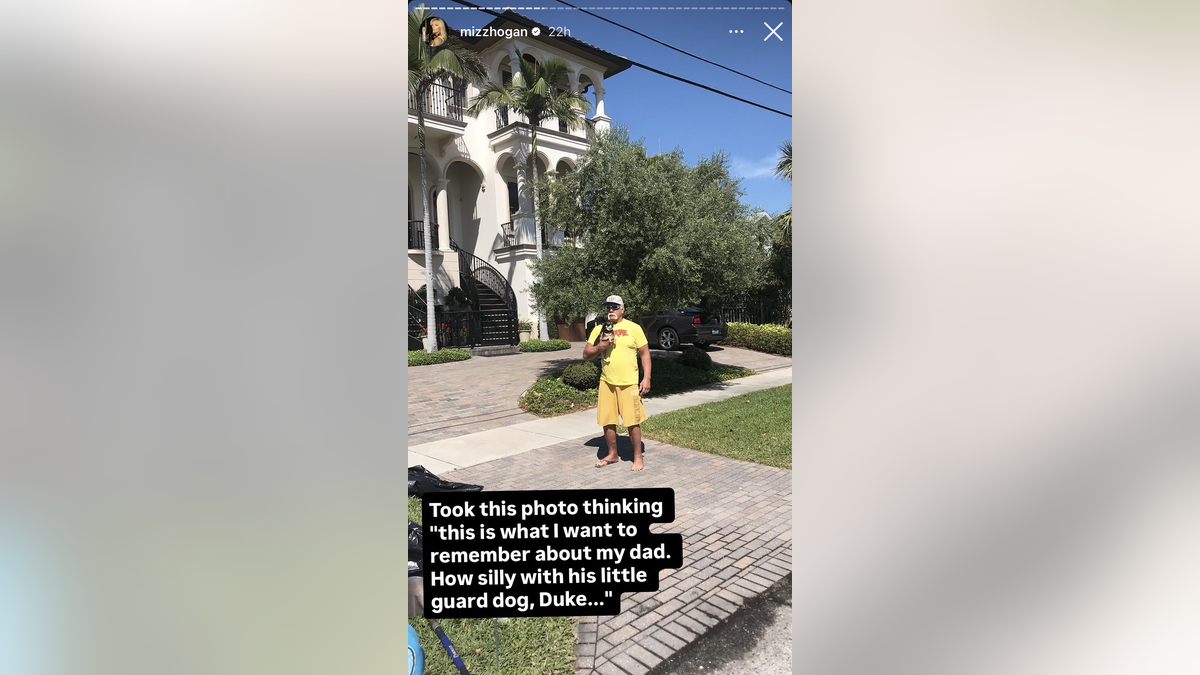 Hulk Hogan with his dog in front of his house