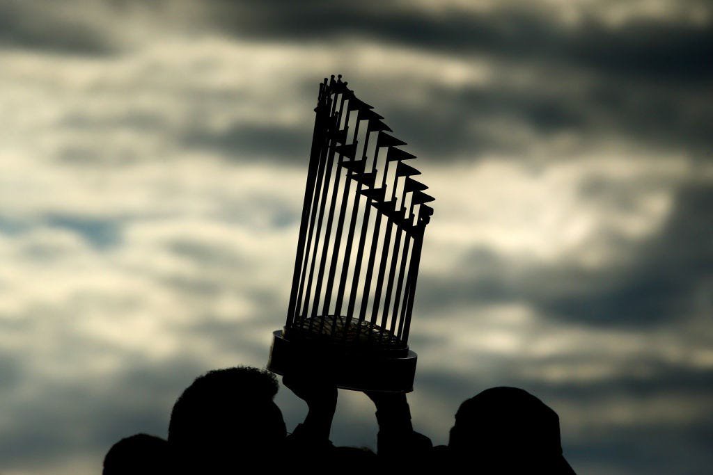 BOSTON, MA - OCTOBER 31:  The World Series trophy is hoisted in the air during the 2018 World Series victory parade for the Boston Red Sox on October 31, 2018 in Boston, Massachusetts. (Photo by Adam Glanzman/Getty Images)