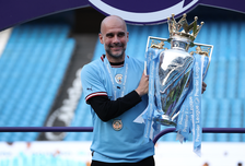 Manchester City manager Pep Guardiola celebrates with the Premier League trophy