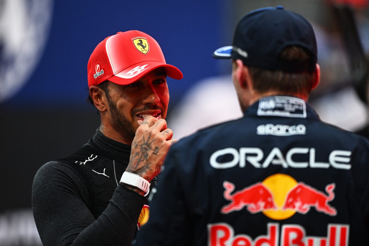 Ferrari driver Lewis Hamilton speaks to Red Bull's Max Verstappen in parc ferme after the F1 Sprint at the 2026 Singapore Grand Prix