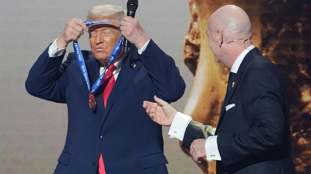 President Donald Trump is presented with the inaugural FIFA Peace Prize by FIFA President Gianni Infantino during the 2026 FIFA World Cup draw at the Kennedy Center, Dec. 5, 2025, in Washington. (AP Photo)