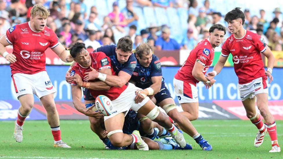 Scarlets back row Sam Lousi offloads the ball in the tackle