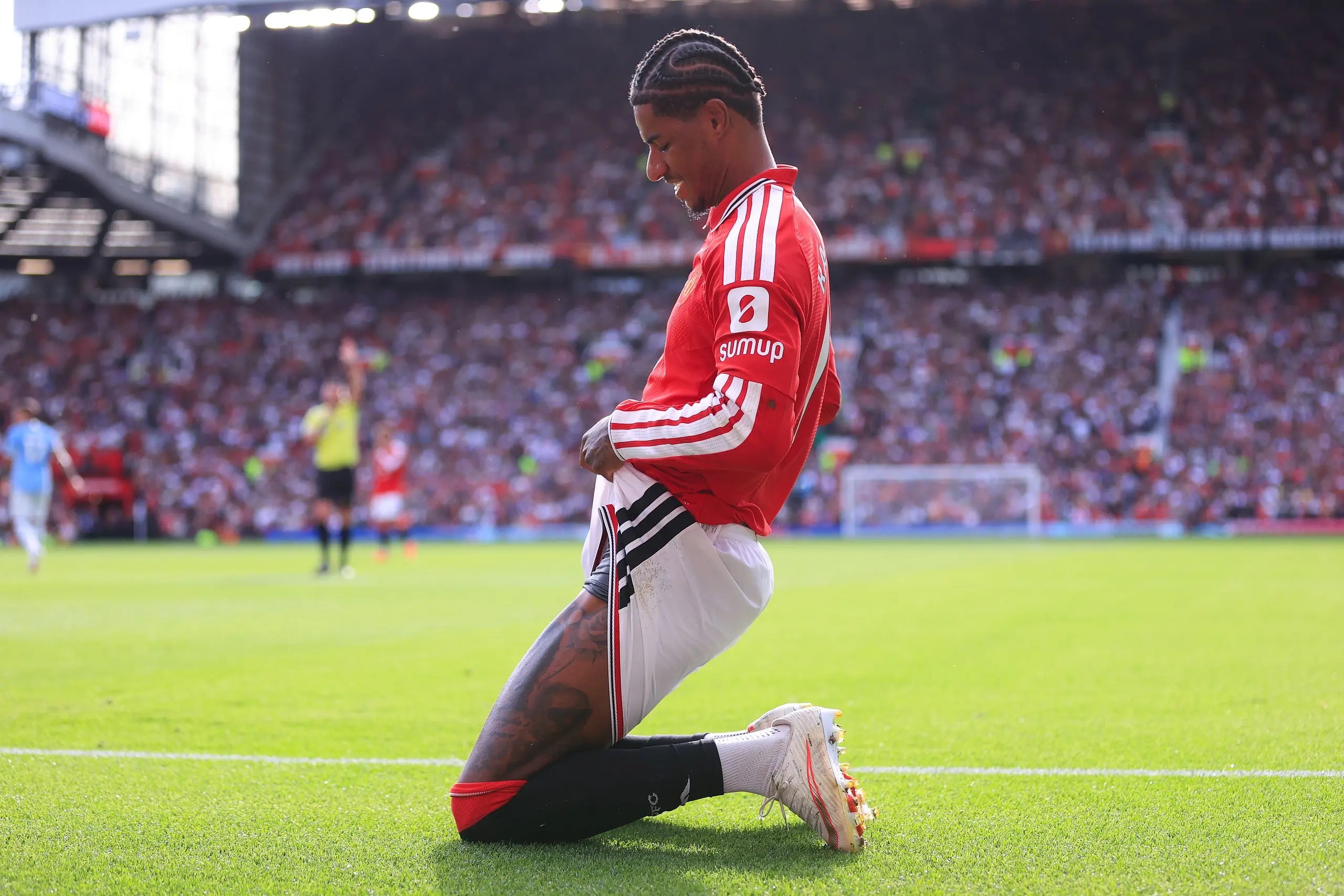 Marcus Rashford on his knees.