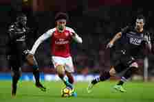 Arsenal's Reiss Nelson beats the challenge of Crystal Palace's Bakary Sako (left) during the Premier League match between Arsenal and Crystal Palac...